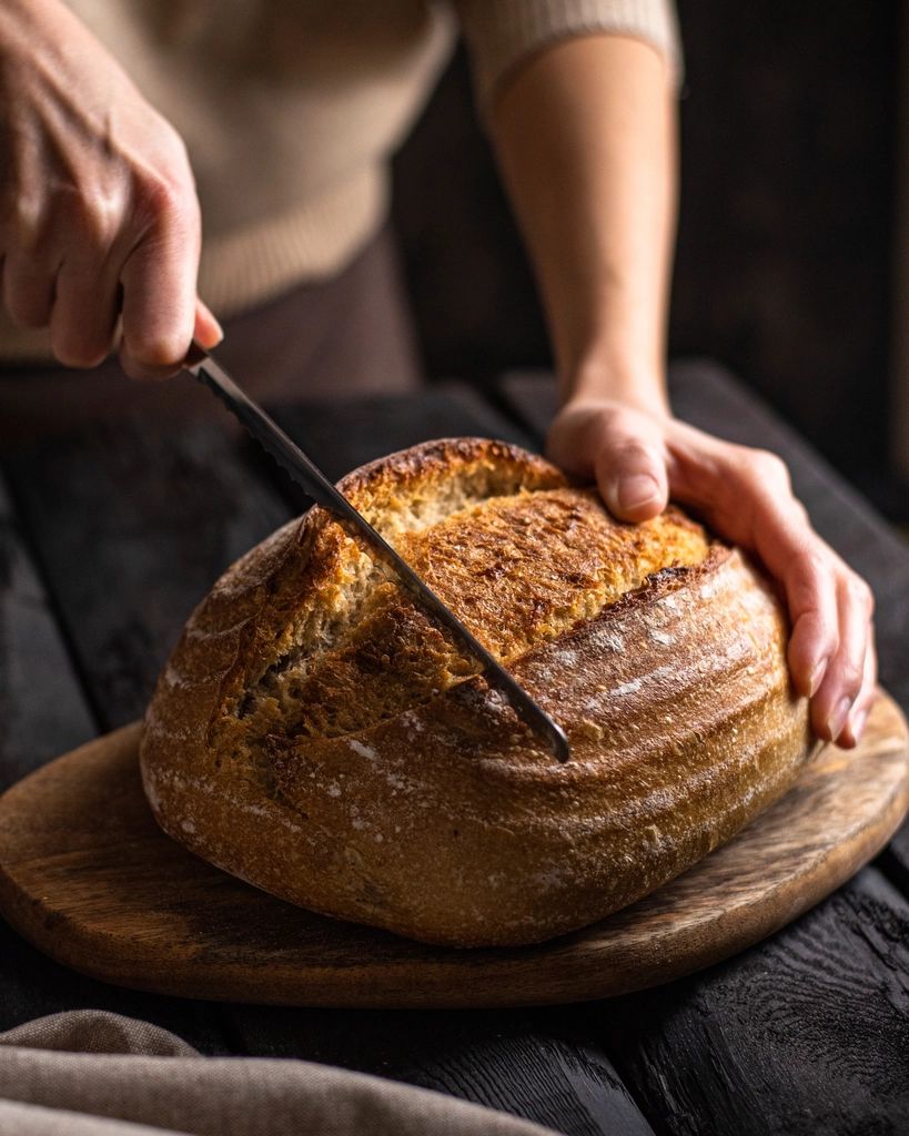 Sourdough loaf being sliced