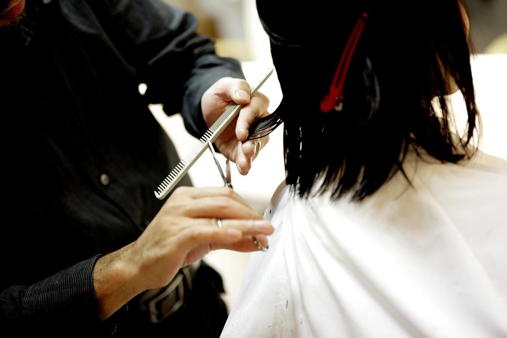 Stylist cutting hair